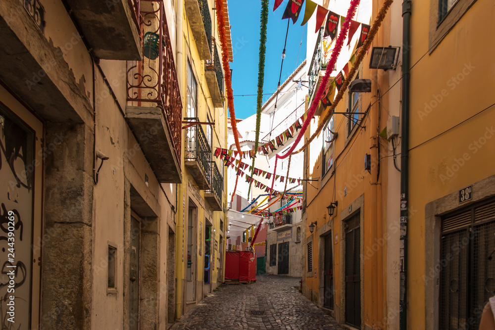 Lisbon, Portugal, June 16, 2018: Old narrow streets in Lisbon with different decorations