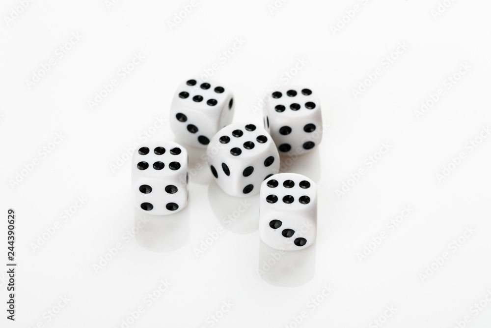 Pile of white with black dots dice with number six on a white background Pile of white with black dots dice with number six on a white background