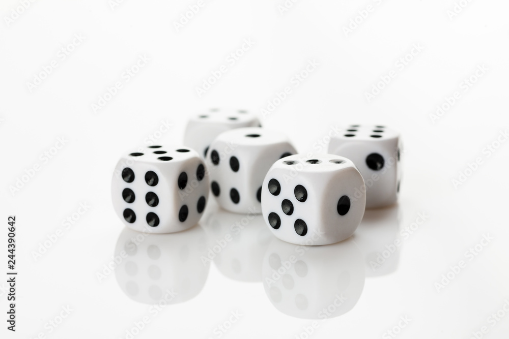 Pile of white with black dots dice on a white background Pile of white with black dots dice on a white background