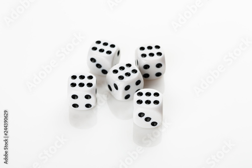 Pile of white with black dots dice with number six on a white background