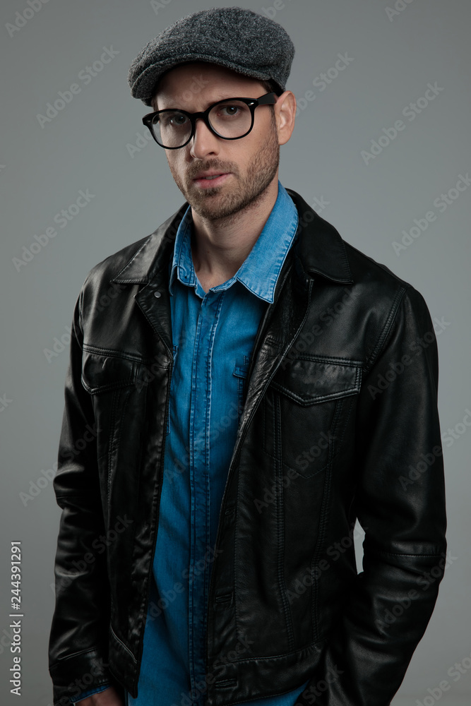 relaxed fashion man wearing leather jacket and flat cap Stock Photo | Adobe  Stock