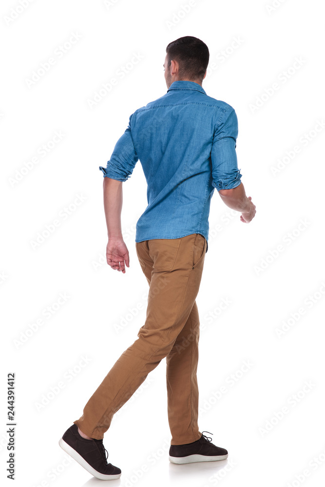handsome casual man steps to side and looks behind handsome casual man steps to side and looks behind