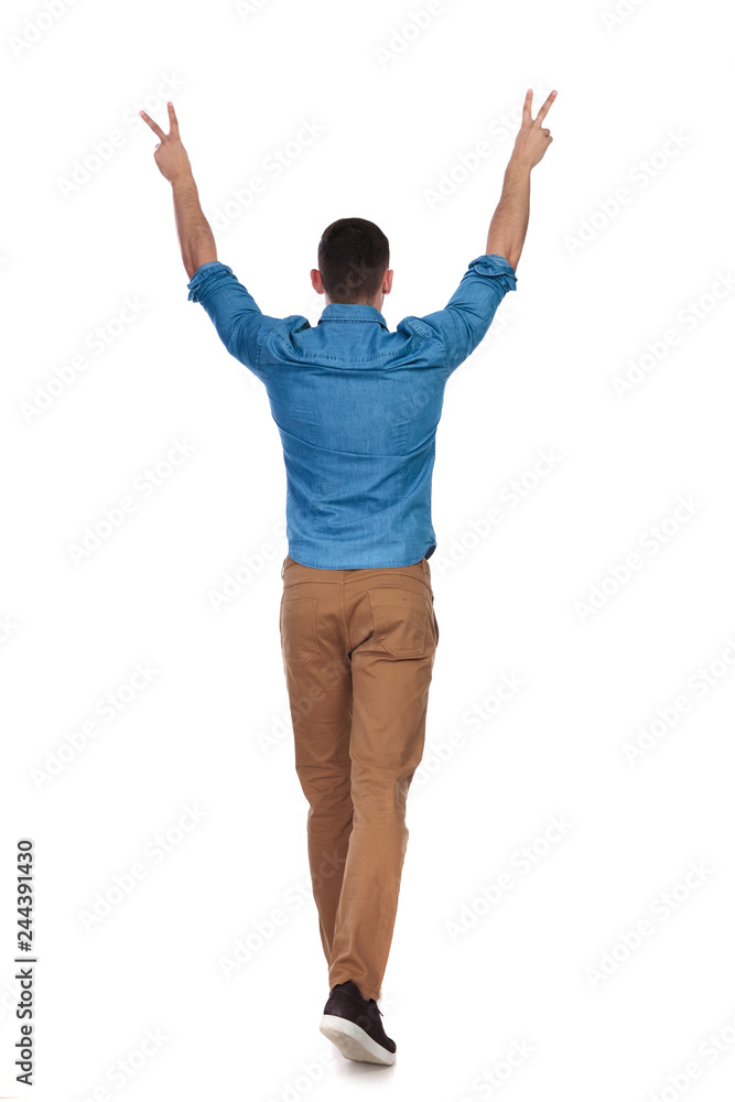 rear view of celebrating casual man walking rear view of celebrating casual man walking