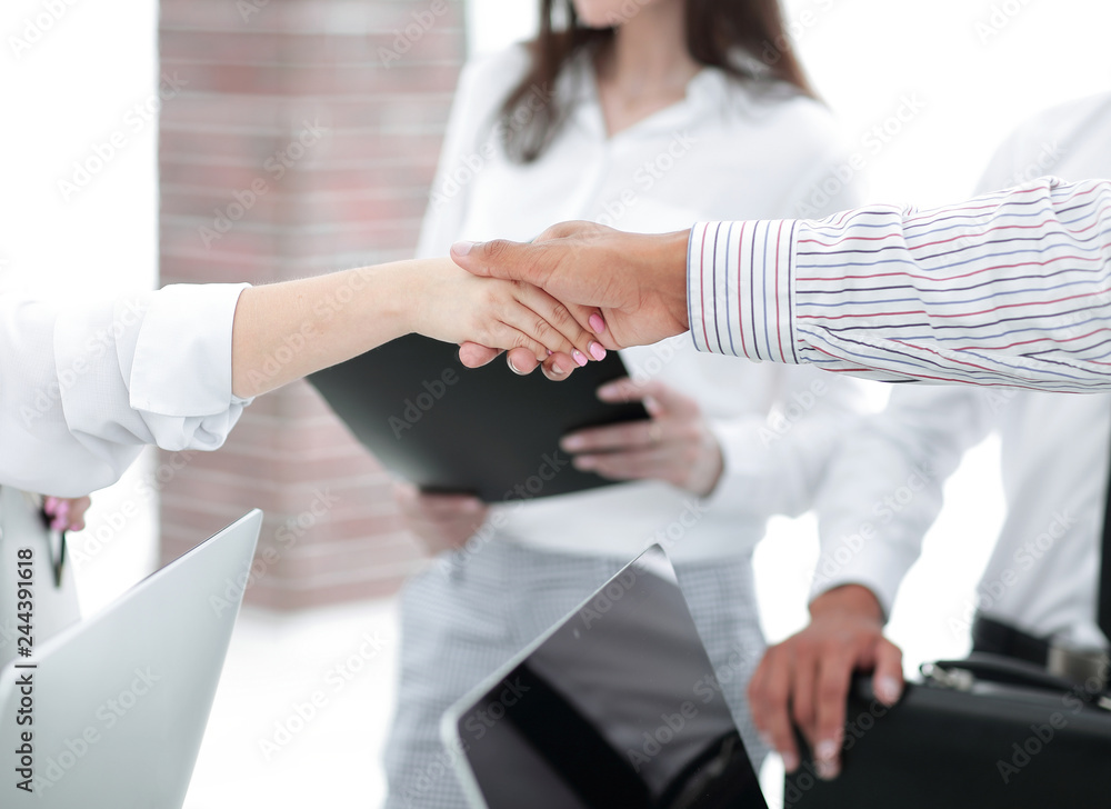 closeup.handshake business colleagues on the background of the office. closeup.handshake business colleagues on the background of the office.