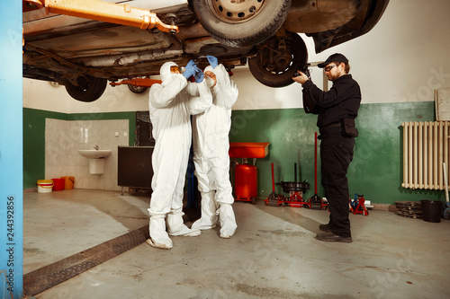 Crime investigation - inspection of suspected car in police garage - chassis observing photo