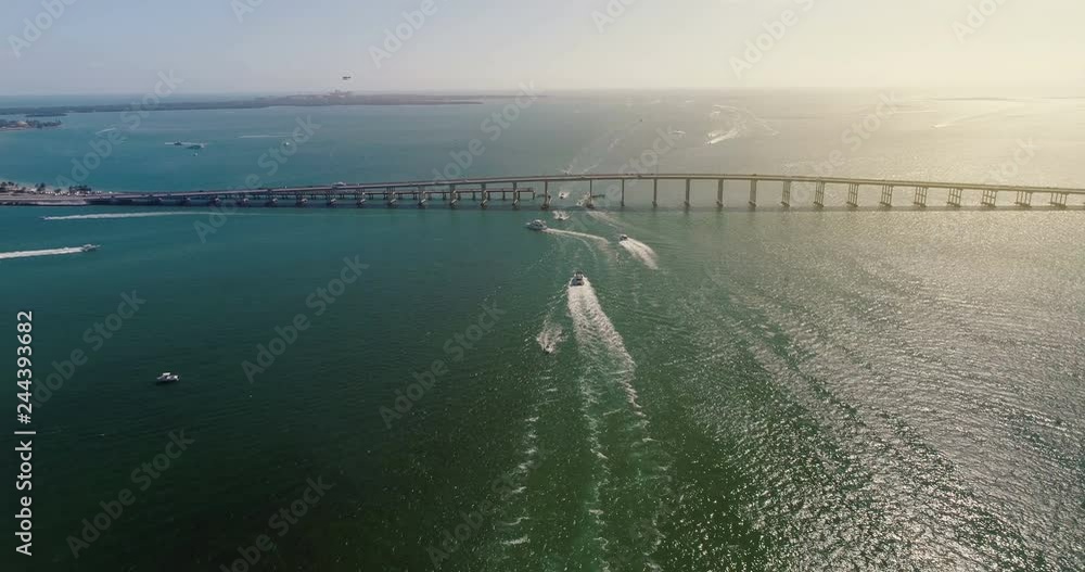 Aerial view of bridge and boats on the ocean, Miami. Light effect Aerial view of bridge and boats on the ocean, Miami. Light effect