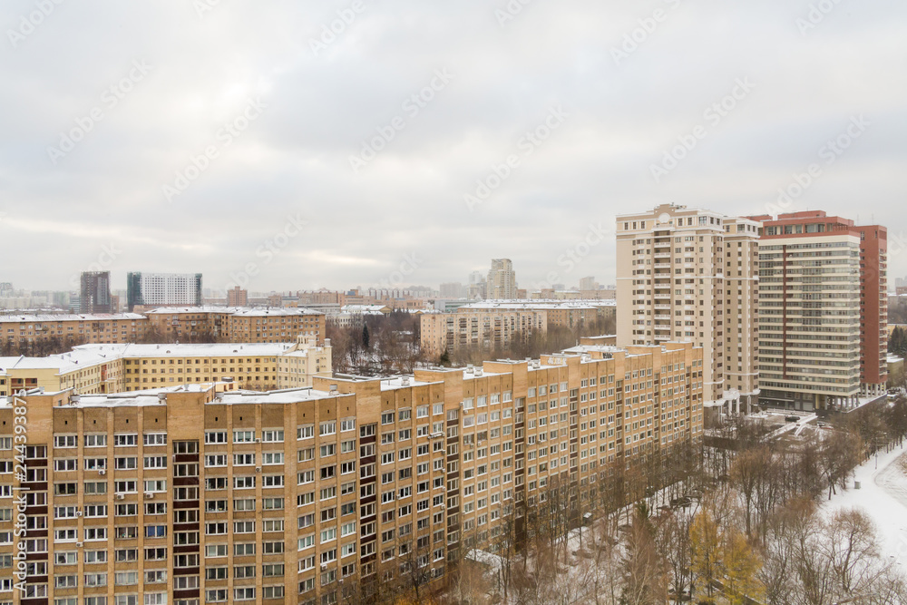 Multi-storey residential buildings in the city. Urban landscape. Winter cloudy day.