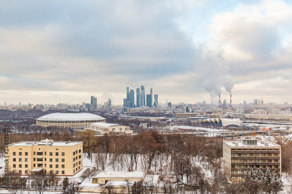 Urban landscape. Winter cloudy day. Smoke from the pipes of the combined heat and power plant. Moscow international business center 