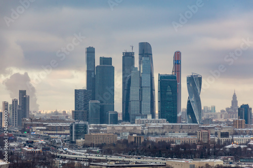 Urban landscape. Winter cloudy day. Smoke from the pipes of the combined heat and power plant. Moscow international business center "Moscow-city".