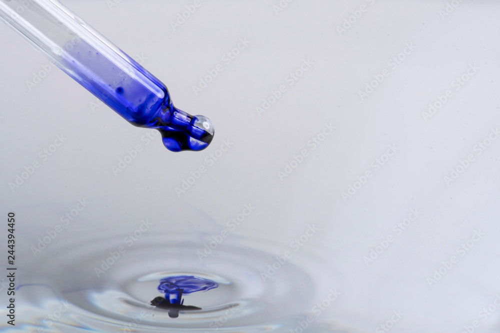 blue ink dripping on a water surface with small waves Stock Photo ...