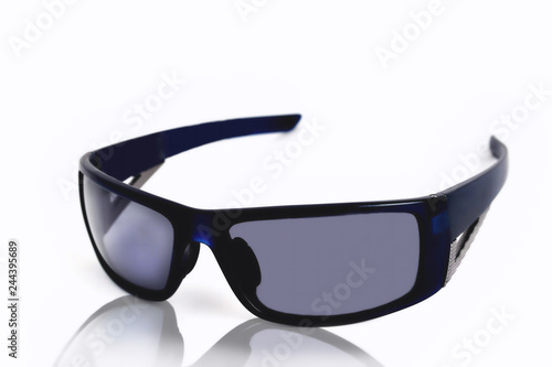 blue sports glasses on a white background, reflection close-up