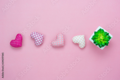 Table top view aerial image of decoration valentine's day or earth day background concept.Flat lay essential items tree pot and colorful love shape on modern pink paper.blank space for mock up.
