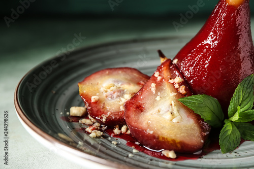 Fototapeta Naklejka Na Ścianę i Meble -  Sweet pears stewed in red wine on plate, closeup