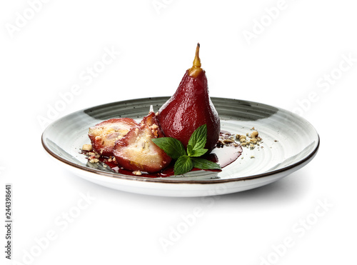 Plate with sweet pears stewed in red wine on white background