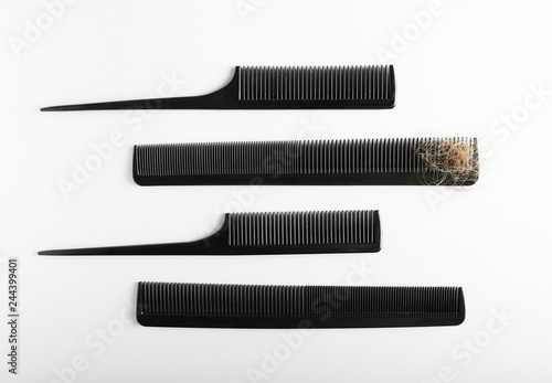 Combs with fallen down hair on white background