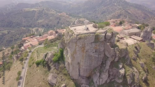 Stunning orbit 4k drone aerial footage around the rock and Catholic cross in Bova, a small Italian village in the hills in Calabria