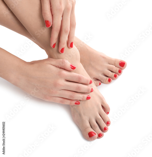 Female legs with beautiful pedicure on white background