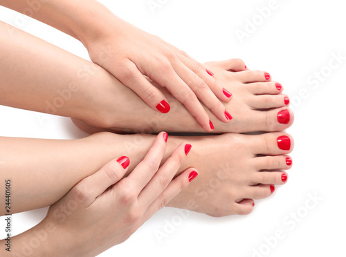 Female legs with beautiful pedicure on white background