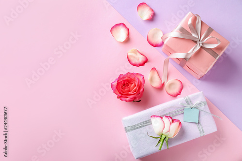 Composition with gift boxes and flower petals on color background © Pixel-Shot