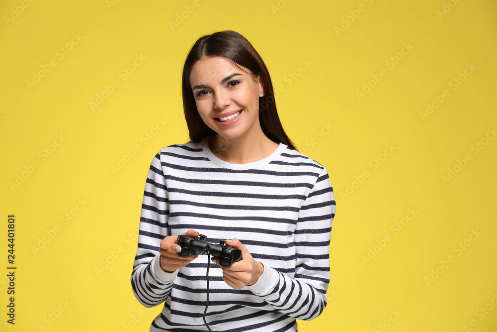 Beautiful young woman playing computer game on color background Beautiful young woman playing computer game on color background