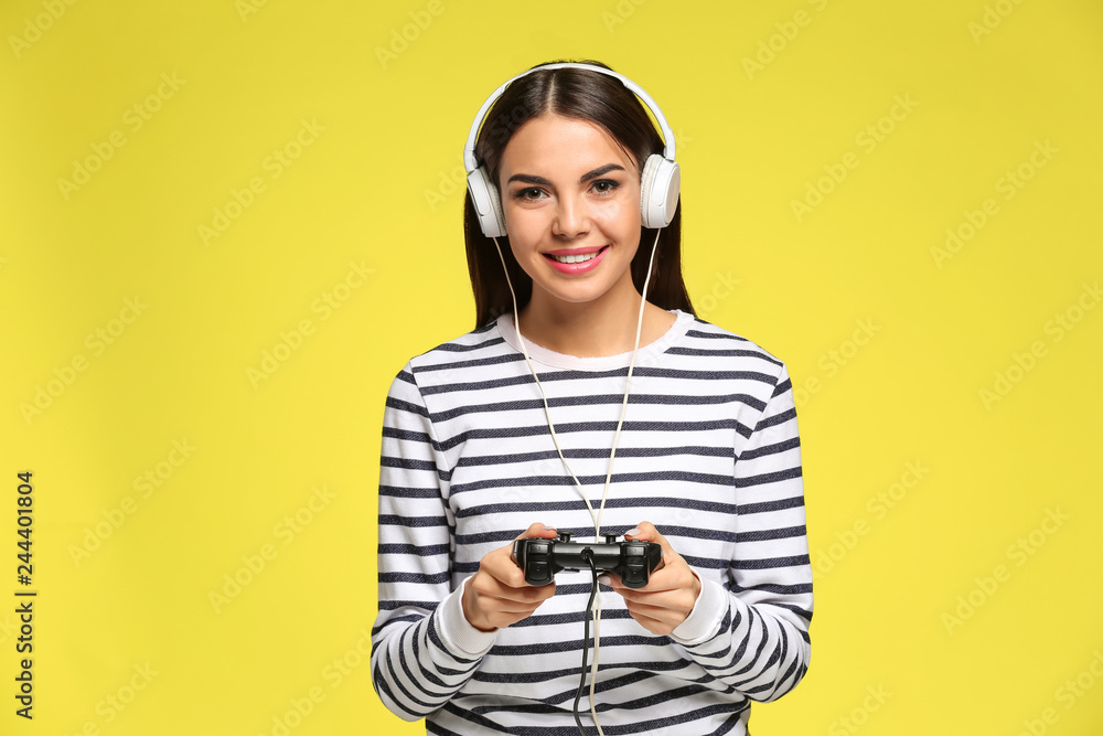 Beautiful happy woman playing computer game on color background Beautiful happy woman playing computer game on color background