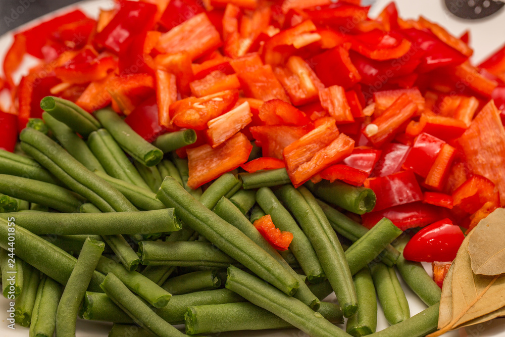 Close up of chopped red pepper and green beans