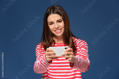 Emotional young woman playi...