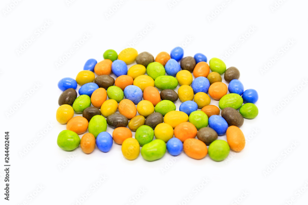 Bright multicolored glazed chocolate candies on white Bright multicolored glazed chocolate candies on white