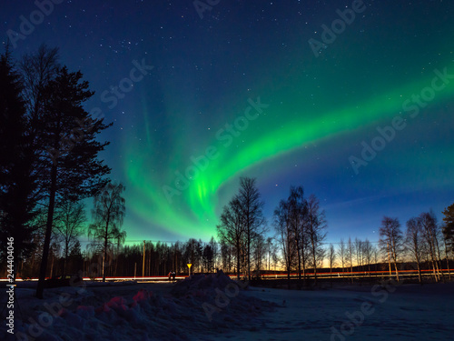 Northern lights above the road in Finnish Lapland
