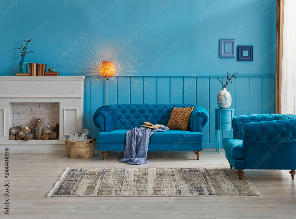 Blue living room, blue wall and background, blue sofa and chair decoration,  carpet, blanket and lamp style. Photos | Adobe Stock