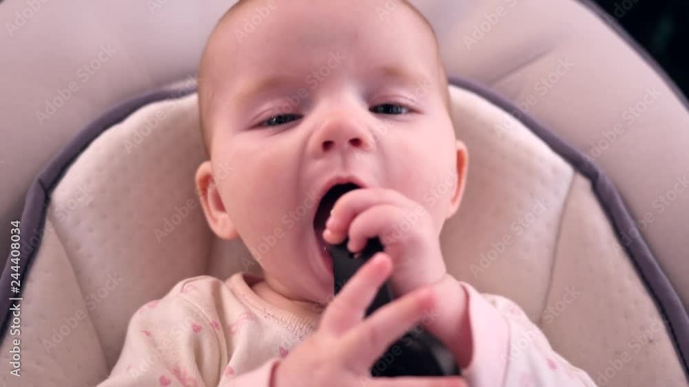 Five months baby girl lie play and try to take in mouth handwatch strap Five months baby girl lie play and try to take in mouth handwatch strap