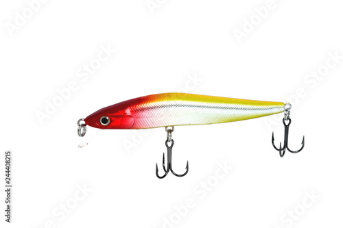 Fishing wobbler with red head, yellow back and white belly. Close-up on a white background.