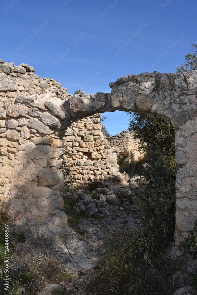 Ruined houses and crumbling walls in the abandoned Moorish village of L'Atzuvieta, Vall de Alcala, Marina Alta, Alicante Province, Valencia, Spain