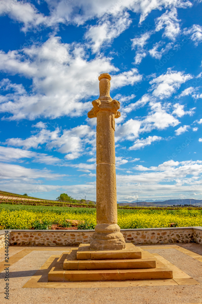 La Picota or Rollo de Azofra, an ancient roadside stone column, route Azofra-Ciruena on the Way of St. James, Camino de Santiago in La Rioja, Spain against a beautiful May sky