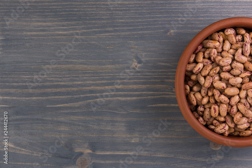 A plate of beans on wooden table background photo