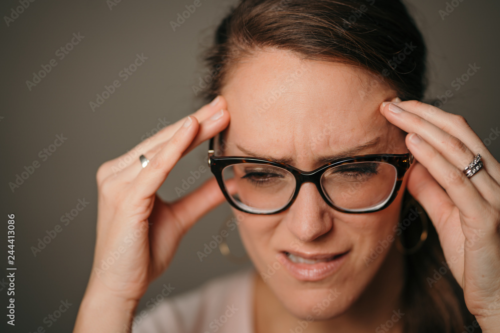 Woman with eyeglasses and headache 