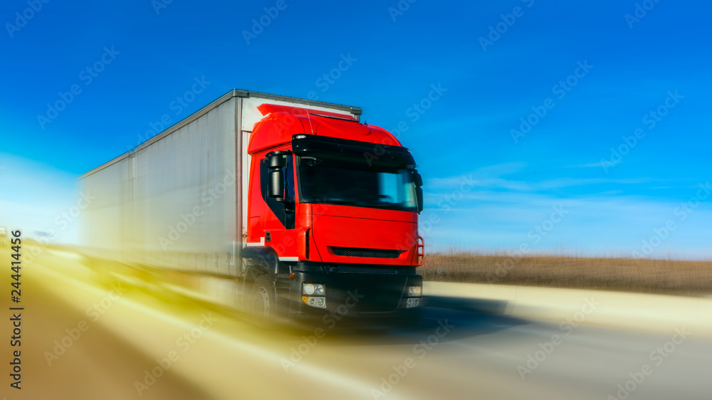 Red truck moving on a highway . Container on the big highway. transport loads