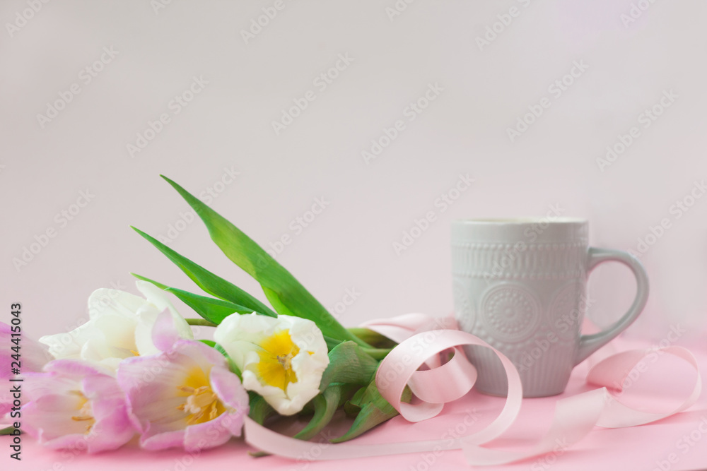 Bouquet of tulips and a coffee cup on a pink pastel background. Wonderful spring breakfast on Mother's Day or Women. Flat lay. View top. Selective focus. Bouquet of tulips and a coffee cup on a pink pastel background. Wonderful spring breakfast on Mother's Day or Women. Flat lay. View top. Selective focus.