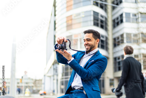 Vászonkép Business man on suit taking a picture outdoors.