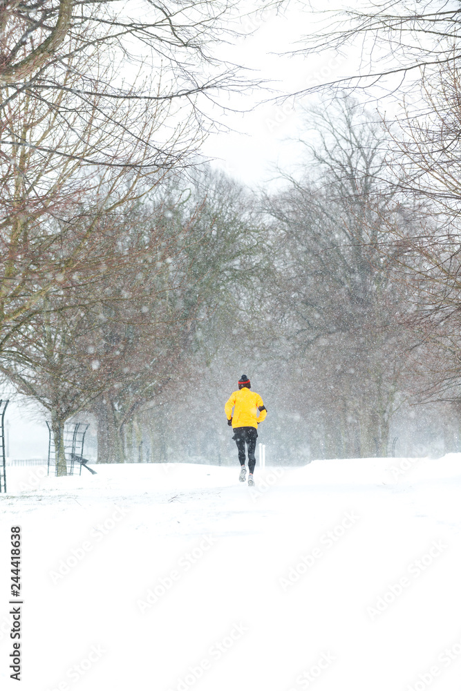 Man running in a heavy snowy day in Dublin,Ireland.