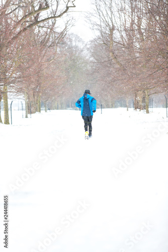 Man running in a snowy day.