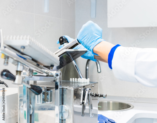 Pharmacist working in laboratory with encapsulator machine