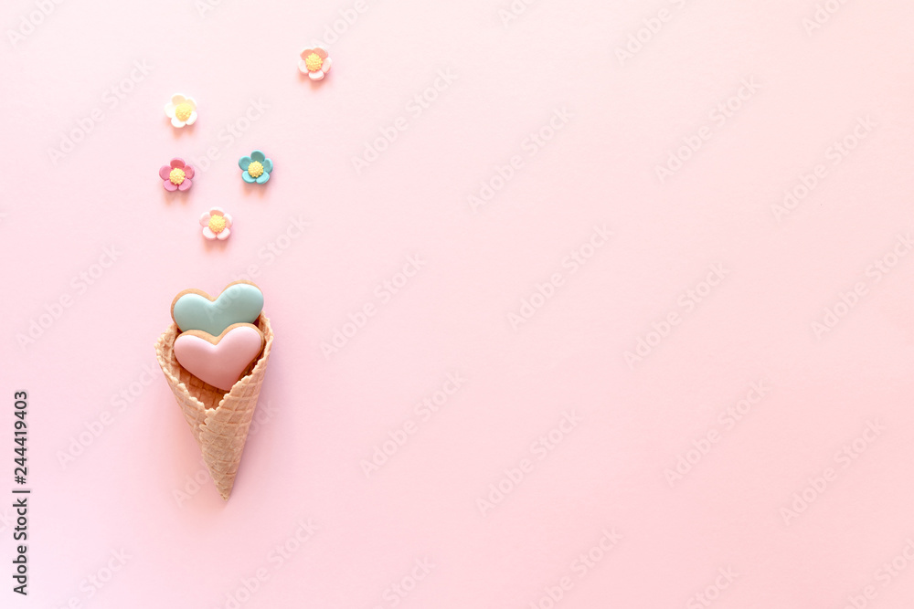Valentine's day background. Ice cream waffle cone with ginger cookie in shape heart on pink background. Valentine day concept, design. Flat lay, top view, copy space
