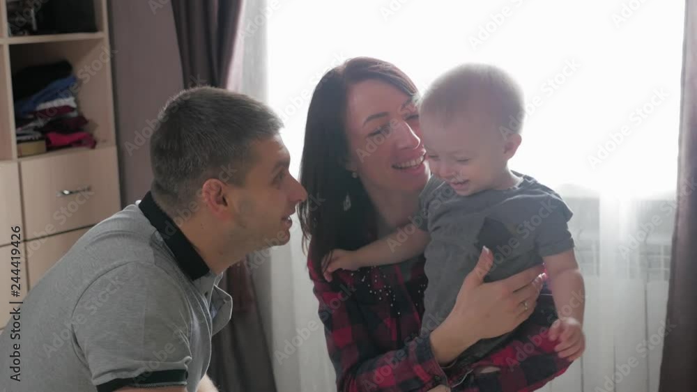 Family, parenthood and people concept - happy mother and father playing with little baby at home. Family, parenthood and people concept - happy mother and father playing with little baby at home.
