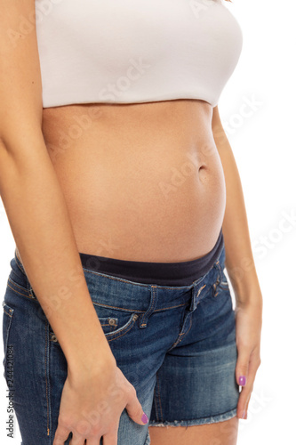 Young woman, early pregnancy, isolated on white background, close-up © Анна Демидова