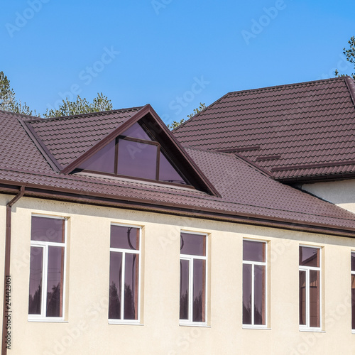 House with plastic windows and roof of corrugated sheet. Roofing