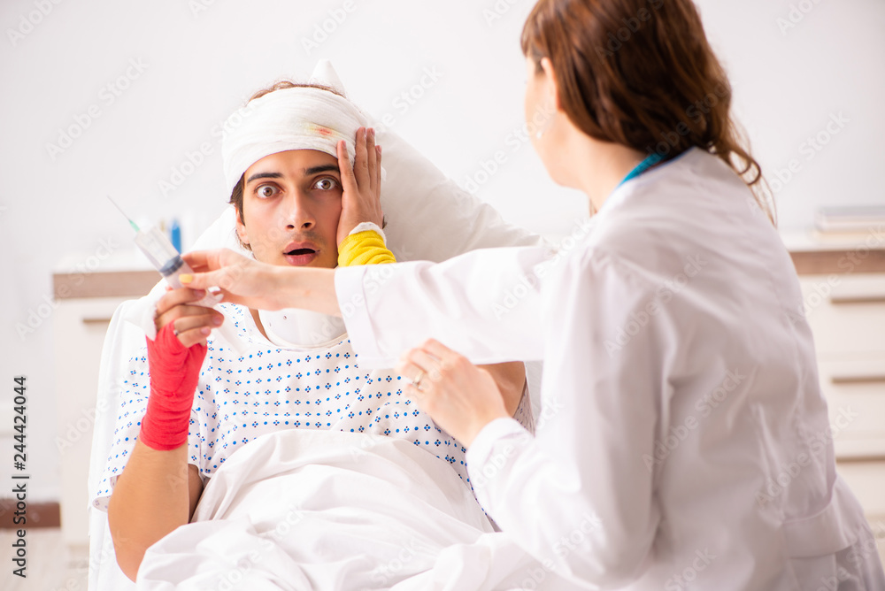 Young doctor examining injured patient Young doctor examining injured patient