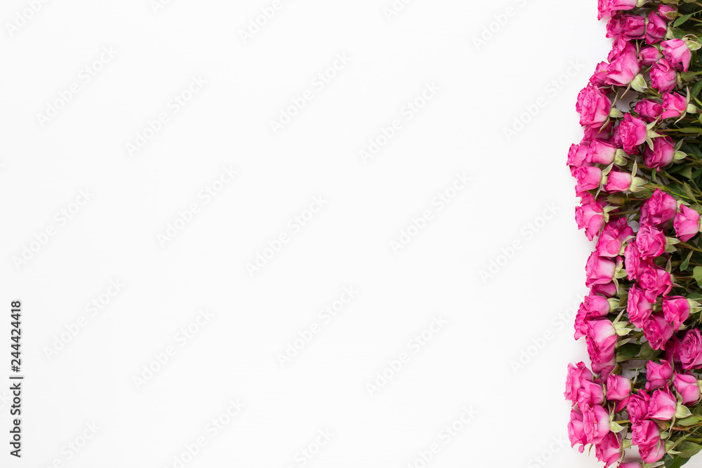 Flowers composition. Frame made of red rose on white wooden background. Flat lay, top view, copy space. Flowers composition. Frame made of red rose on white wooden background. Flat lay, top view, copy space.