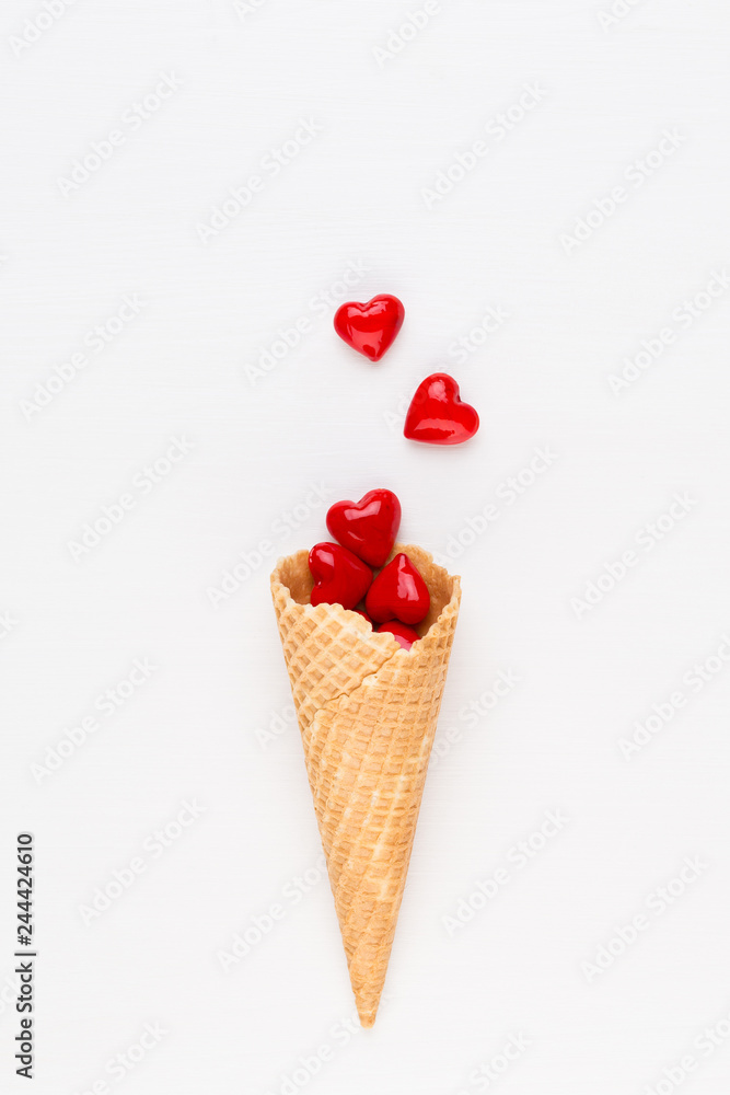 Creative composition for Valentines day with waffle cone, mixed hearts on white background top view. Fashion flat lay. Creative composition for Valentines day with waffle cone, mixed hearts on white background top view. Fashion flat lay.