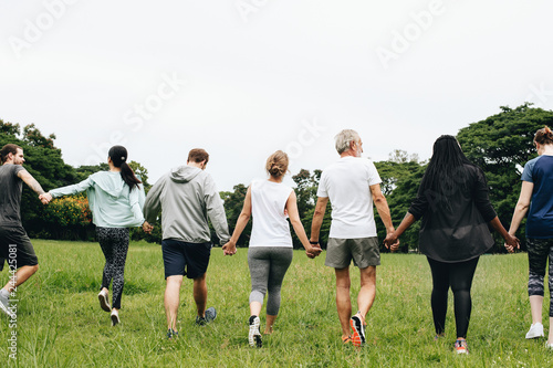 Group of adults holding hands in the park